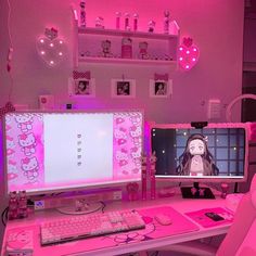 a desk with a computer monitor, keyboard and mouse on it in a pink room