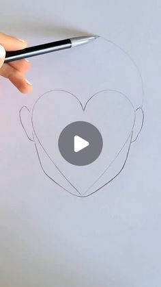 someone is drawing a heart with a marker