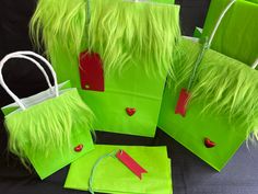 four bags with green fur and red hearts on them