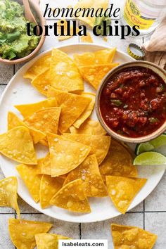 homemade tortilla chips on a plate with salsa and guacamole