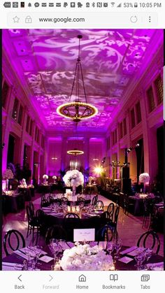 an elegant ballroom with purple lighting and white flowers