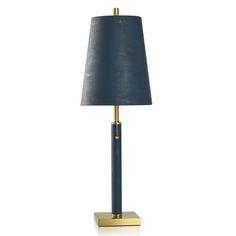 a table lamp with a blue shade on the base and a gold plated base