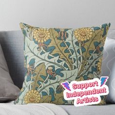 a pillow with the words support independent artists on it sitting on a couch next to pillows