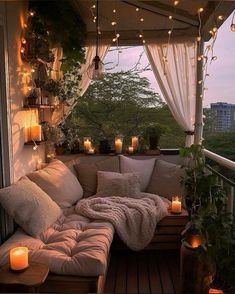 a couch on a balcony with candles lit up