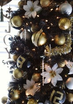 a christmas tree decorated with gold and white ornaments