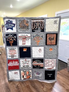 a quilt made to look like an orange and black college football team is on display