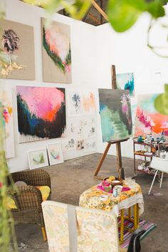 an art studio with paintings on the wall