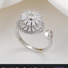 a diamond ring on top of a white cloth with the words, beautiful fine jewelry