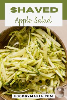 shaved apple salad in a wooden bowl with spoons on the side and text overlay