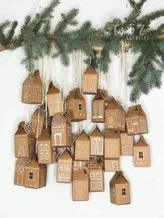 a group of gingerbread houses hanging from a christmas tree