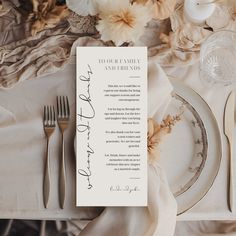 a place setting with silverware and flowers