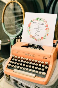 an old fashioned typewriter sitting on top of a table