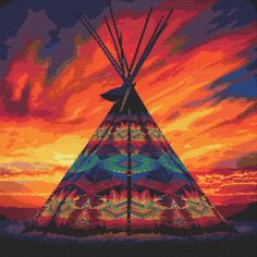 a teepee with the sun setting in the background