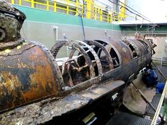 an old rusted engine sitting on top of a conveyor belt