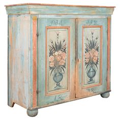 an old painted cabinet with flowers on it