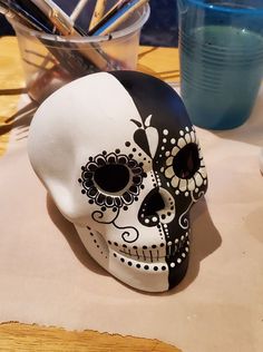 a white and black skull sitting on top of a table