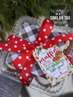 a glass container filled with cookies wrapped in red ribbon