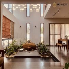 a living room filled with furniture and plants