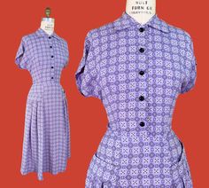 vintage 1940s dress, made of a breezy rayon blend (*I think blended with nylon!)  ➡ lavender, black + white bandana novelty print ➡ post-war silhouette with cap sleeves + fitted waist + full skirt  ➡ black plastic buttons up the bodice, with little hidden snap under the collar  ➡ faux hip shelf pockets, crowning bands of wide pleated drape ➡ side metal zipper closure  label: none present material: rayon blend (probably with nylon)  garment is shown pinned on my 34"/25"/36" form, for reference. White Bandana, Black Bandana, Dress Lavender, Pleated Drapes, 1940s Dresses, 1940s Fashion, 50s Fashion, Novelty Print, Day Dress