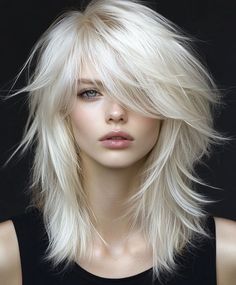 Add waves to your platinum blonde shag with a side-swept fringe for a softer, more relaxed look. The waves enhance the texture of the shag cut, creating a beachy, carefree vibe that’s perfect for everyday wear. Long Layered White Hair, Wolf Cut Blonde Hair, Platinum Blonde Shag, Hair Color Platinum, Blonde Hair With Fringe, Blonde Shag, Feathered Fringe, Blonde Transformation