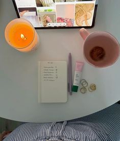 a table topped with a cup of coffee next to a cell phone and other items