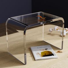 a glass table with a magazine underneath it