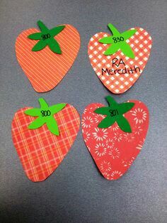 four strawberry shaped magnets with the names of each individual