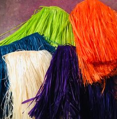 three different colored fringes sitting next to each other