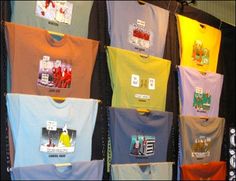 t - shirts are hanging on the wall in front of each other, with different colors and designs