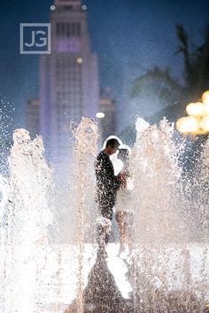 two different shots of people playing in the water at night and then taking pictures with their cell phones