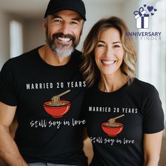 a man and woman wearing t - shirts that read married 20 years still say i love you