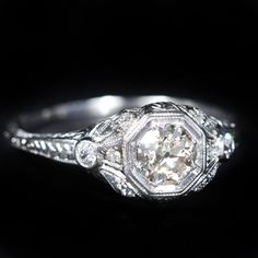 an antique diamond ring with filigree accents