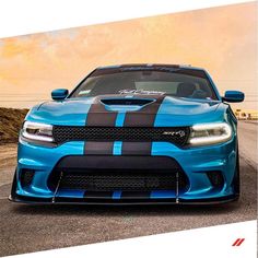 the front end of a blue and black dodge charger