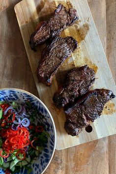 the steaks are ready to be cooked on the grill and served with fresh salad