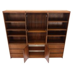 a large wooden bookcase with two doors and three drawers on the front, one door open