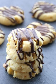 several cookies with chocolate drizzled on them