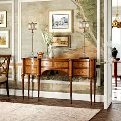 a living room scene with focus on the sideboard and table in the foreground