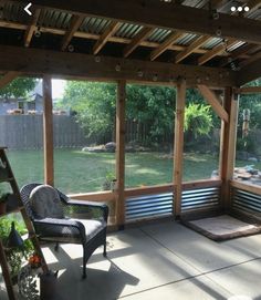 a covered patio with a bench and chair