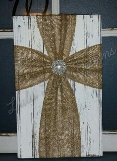 a door hanger decorated with burlock and a bow on the front porch