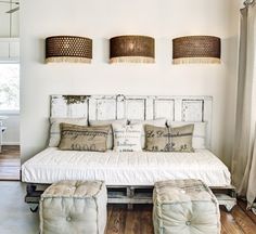 a white bed sitting in a bedroom next to two lamps