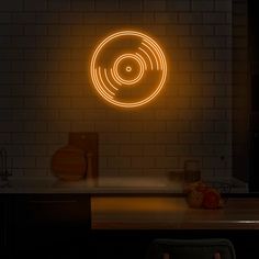 a record player neon sign on the wall next to a kitchen counter with utensils