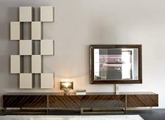 a living room with a large mirror on the wall next to a table and lamp