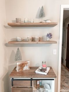 two shelves with candles and other items on them