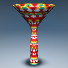 a colorful glass vase sitting on top of a table