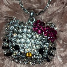 the hello kitty necklace has been made with swarong crystals and other sequins