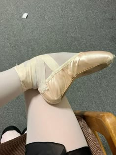 a ballerina's leg wearing ballet shoes and stockings