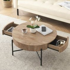 a coffee table with an open drawer underneath it in the middle of a living room