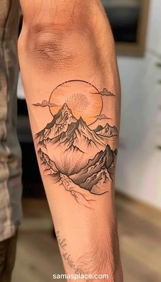 a man with a mountain tattoo on his arm