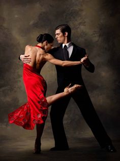 a man and woman in formal wear dancing