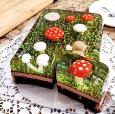 there are two slices of cake that have mushrooms on them and grass in the middle